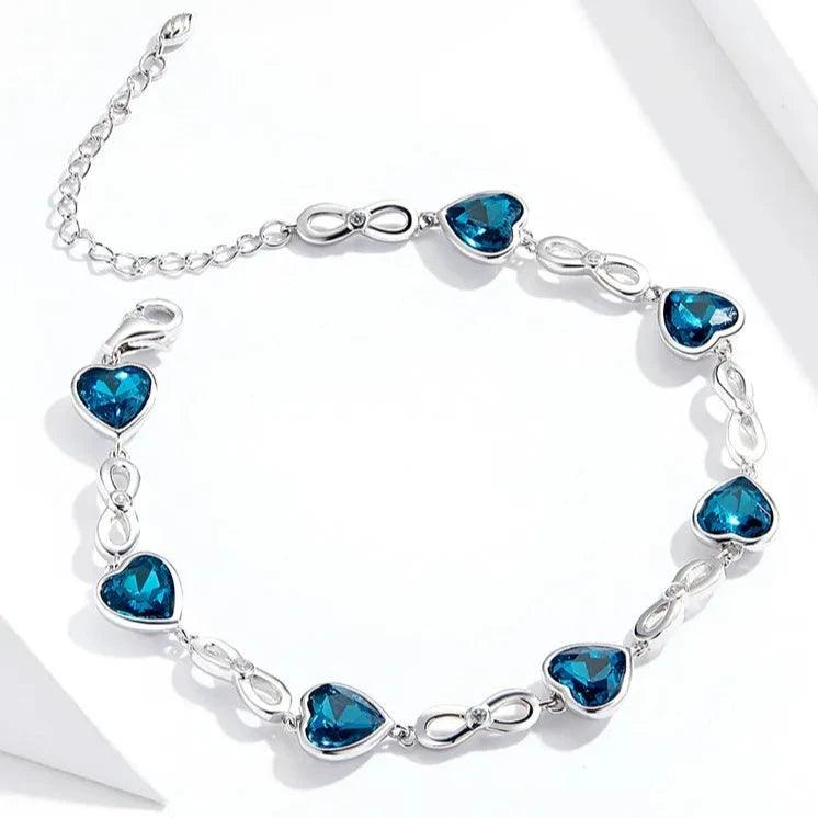 Pulseira de Prata Infinito e Coração Azul: Elegância e Simbolismo para seu Look - ORIENTE PRIME